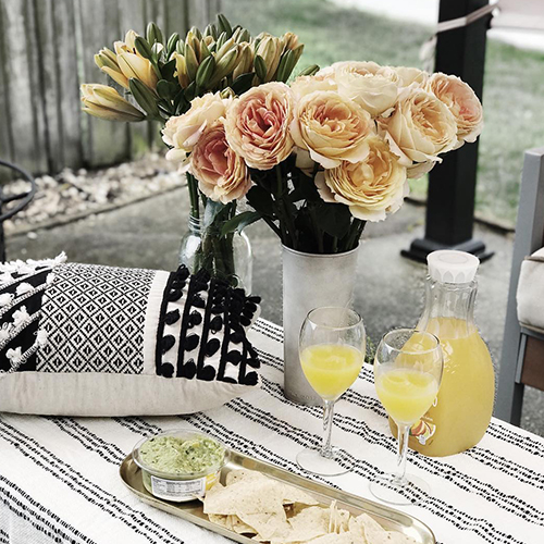 Peach Roses and Yellow Lilies At An Outdoor Picnic