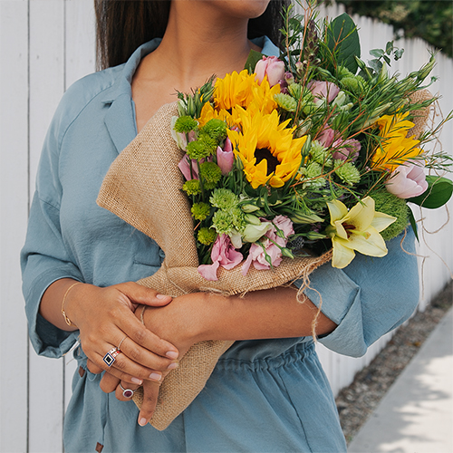 Woman Cradling Sunflowers
